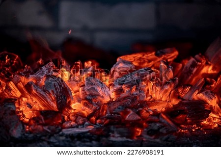 Flame of fire from hot burning coals in the fireplace. Heat from the oven. High quality photo