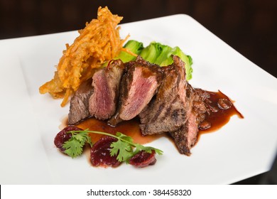 Flame grilled ,rare kangaroo steak loin, served with pak choi and a red wine sauce - Shutterstock ID 384458320