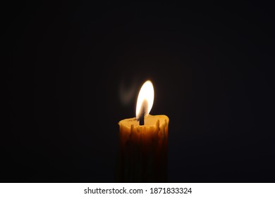 The flame produced by the lighting of a candle  To light up the night  Or to deny the atmosphere - Shutterstock ID 1871833324