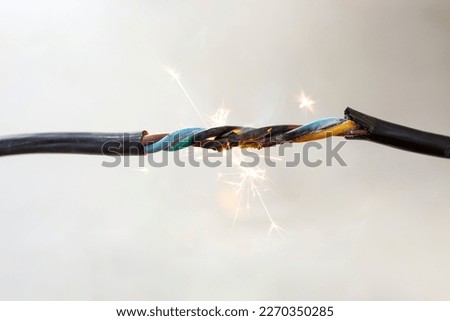 flame smoke and sparks on an electrical cable, fire hazard concept, soft focus close up Foto stock © 