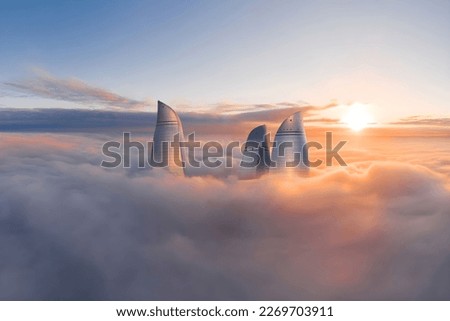 Flame towers among the clouds, Baku Azerbaijan. Orange frequent clouds.