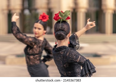 Flamenco Ballerina On Her Back With Bun Hair And A Rose On Her Head