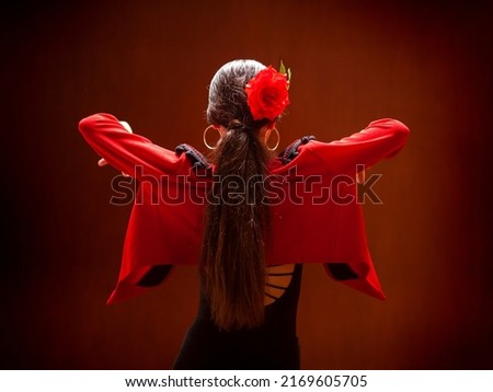 Flamenco dancer dressed in red jacket