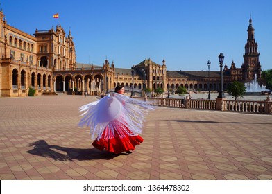 Flamenco Dancer Wearing Red Dress Twirling In The Dance With Spanish Shawl On Plaza De Espana In Seville, Spain