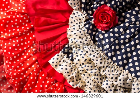 Flamenco dresses in red and blue with spot with red rose typical from Spain Espana