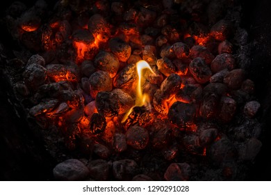 Flames and coals of a fire burning at night . Background of hot coals.