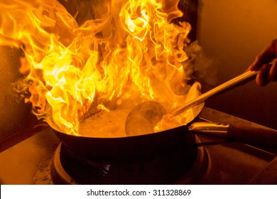 Flames Leaping From A Wok Whilt Cooking