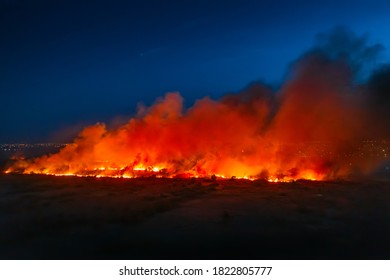 Flames Of Massive Forest Fire, Aerial View At Night. Nature Wildfire In Dry Season. Burning Trees And Meadows