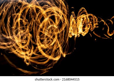 Flames On Long Hatchet. Traces Of Fire In Dark. Flames Spread Chaotically In Space.