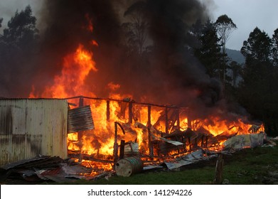 Flames And Smoke Rise From Burning Building