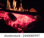 Flames of a stone pit fire at night in dark background at a campground state park in Washington State