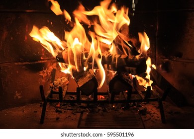 Flames in the wood fireplace - Shutterstock ID 595501196