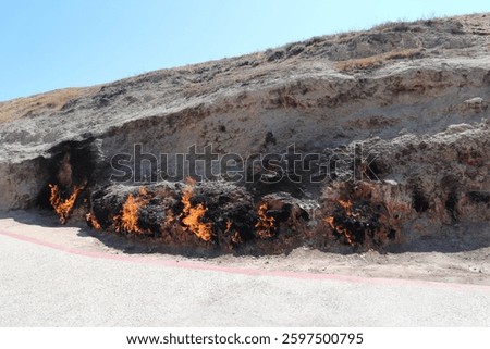 Flames of Yanar Dag, a mesmerizing view of Azerbaijan’s eternal fire, where natural gas seeps through the earth and ignites, creating a surreal landscape.