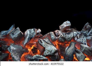 Flaming Charcoal In BBQ Grill Pit Isolated On Black Background