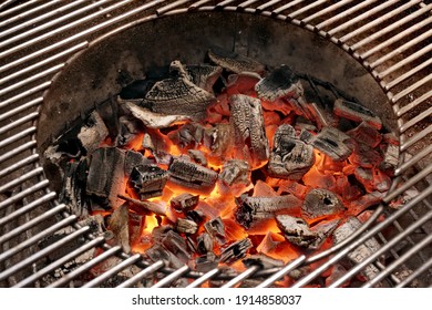 Flaming Charcoal In Kettle Grill Pit. Top View Of BBQ Hot Kettle Grill With Stainless Steel Grid, Isolated Background, Overhead View. Barbecue Kettle Grill On Backyard Ready Grilling Cookout Food.