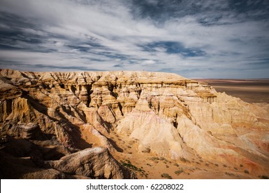 The flaming cliffs of Bayanzag, a region in the Gobi desert of Mongolia famous for discoveries of dinosaur fossils and the first set of dinosaur eggs. Horizontal copy space