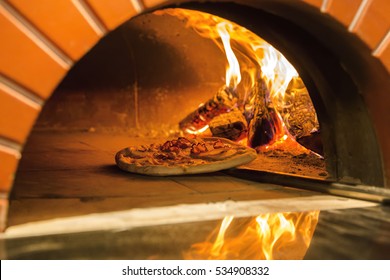 Flaming Hot Wood Fired Pizza Baking in an Oven