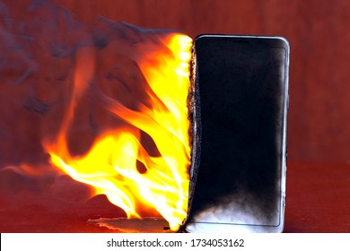 Flaming smartphone. The phone is on. Blank screen of a burning mobile smartphone