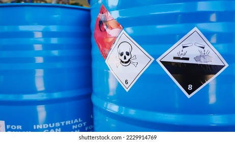 Flammable, acid, volatile, warning labels, mounted on hazardous chemical storage tanks in the warehouse of a chemical industrial factory plant. Waiting for delivery according to the user's order. 