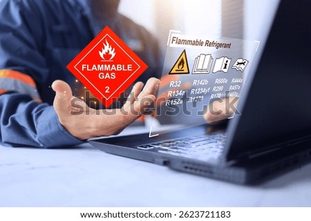 Flammable refrigerant concept with engineer reading warning sign before using the gas to charge in air conditioner and refrigeration system to research and development or service in customer site