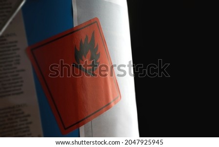 Flammable warning sticker on paint can with black copy space