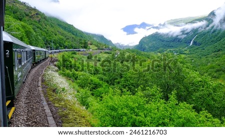 Flamsbana train line running through the beautiful nature view of Norway green forrest and mountains