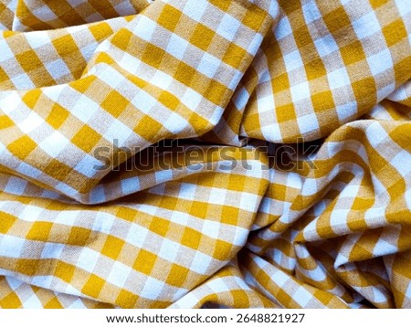 Flannel pattern in yellow and white, closed up texture of yellow and white for background. Picnic table cloth. Yellow plaid fabric for tablecloth. Abstract texture