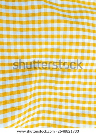 Flannel pattern in yellow and white, closed up texture of yellow and white for background. Picnic table cloth. Yellow plaid fabric for tablecloth. Abstract texture
