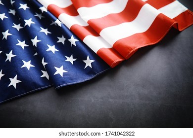 Flapping flag USA with wave. American flag for Memorial Day or 4th of July. Closeup of American flag on dark background