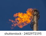 Flare of a coking plant with blue sky