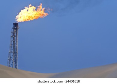 A Flare Stack Burning Off Excess Gas At An Oil Refinery In The Desert