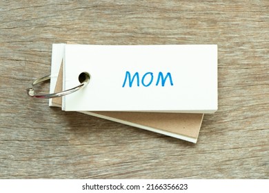 Flash card with handwriting word mom on wood background - Shutterstock ID 2166356623