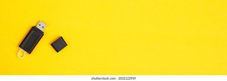 Flash drive for data storage placed on a yellow background