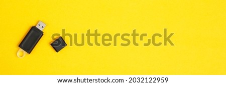 Flash drive for data storage placed on a yellow background