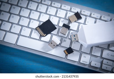 Flash Drive And Memory Cards On The Computer Keyboard. 