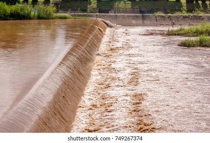 The Flash Flood Is Overflowing Over The Dam, It's Have A Blod Brown Color