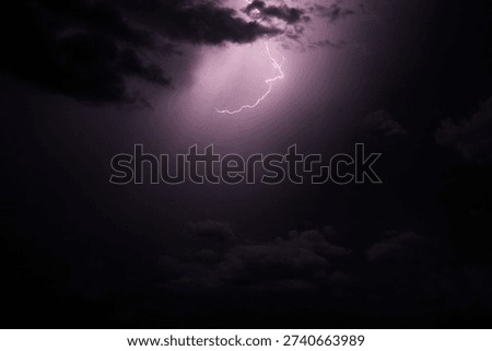 Flash of lightning in midst of thunderstorm at night