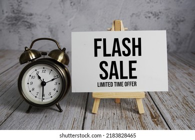 Flash Sale Text Message And Alarm Clock On Wooden Background