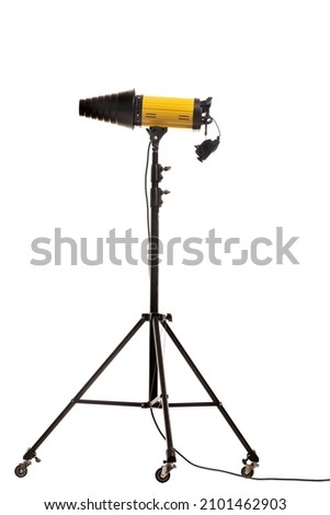Flash strobe with snoot light modificator on stand with wheels. Studio lighting equipment isolated on white background.