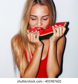 Flash style closeup portrait of young blonde sensual woman eating watermelon 
