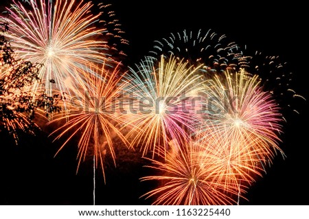 Flashes of fireworks against the black sky.