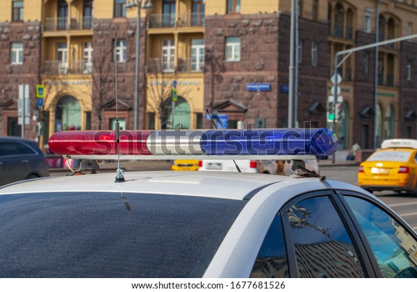 flashing lights of a police car,\
flashing lights of the police car into the checkpoint in the city\
