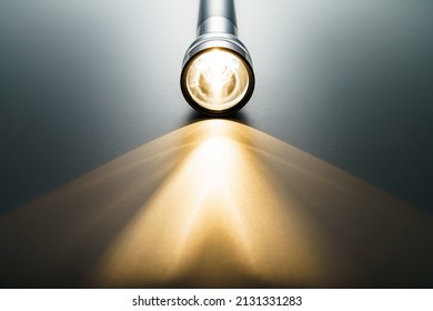 Flashlight isolated on dark background (Flashlight and a beam of light in darkness)