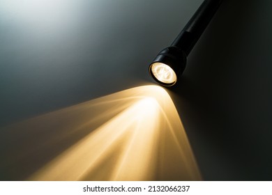 Flashlight Isolated On Dark Background (Flashlight And A Beam Of Light In Darkness)