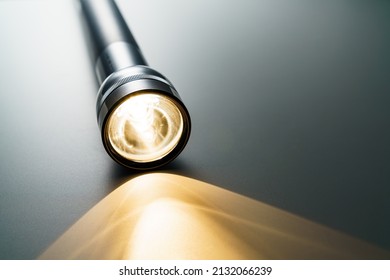 Flashlight isolated on dark background (Flashlight and a beam of light in darkness)