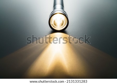 Flashlight isolated on dark background (Flashlight and a beam of light in darkness)