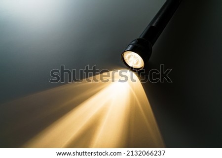 Flashlight isolated on dark background (Flashlight and a beam of light in darkness)