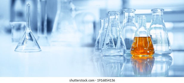 flask and glassware equipment in chemistry science laboratory blue banner background	 - Shutterstock ID 1916854136