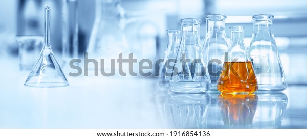 flask and glassware equipment in chemistry\
science laboratory blue banner\
background	