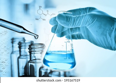 Flask in scientist hand with Test tubes - Shutterstock ID 195167519